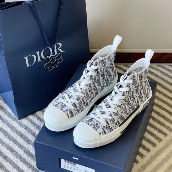Dior B23 High-Top Canvas Trainers Pair with Packaging in black and white Pair of Dior B23 High-Top Canvas Trainers In Black And White beside branded gift bag