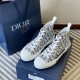 Dior B23 High-Top Canvas Trainers Pair with Packaging in black and white Pair of Dior B23 High-Top Canvas Trainers In Black And White beside branded gift bag