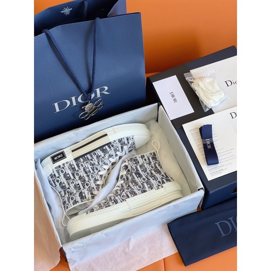 Dior B23 High-Top Canvas Trainers Unboxing View in black and white Unboxing view of Dior B23 High-Top Canvas Trainers In Black And White inside retail box