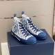 Dior B23 High-Top Oblique Canvas Blue Trainers Three-Quarter Angle Three-quarter front view of Dior B23 High-Top Oblique Canvas Blue Trainers on shoebox
