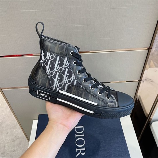 In-Hand Lateral View of Dior High-Top Trainer in grey and white Hand holding dark grey Dior high-top Oblique trainer showing lateral side details in grey and white