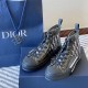Angled Pair View of Dior Dark Grey High-Top Trainers in grey and white Angled front pair view of Dior dark grey high-top trainers with branded box in grey and white