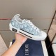 Dior B23 Low Top Oblique Monogram Blue Trainer Lateral View in blue and white Hand holding a Dior B23 Low Top Oblique Monogram Blue Trainer from lateral side angle in blue and white