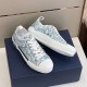 Dior B23 Low Top Oblique Monogram Blue Trainers Display View in blue and white Angled side view of Dior B23 Low Top Oblique Monogram Blue Trainers resting on blue box in blue and white