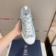 Dior B23 Low Top Oblique Monogram Blue Trainer In Hand in blue and white Top view of a single Dior B23 Low Top Oblique Monogram Blue Trainer held in hand in blue and white
