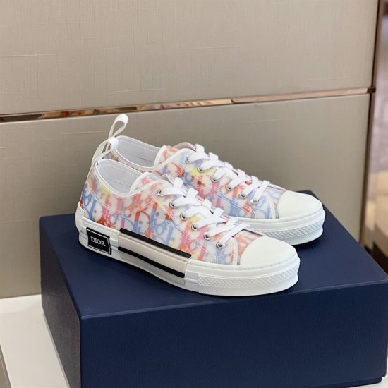 Dior B23 Multicolour Canvas Trainers Perspective in multicolour and white Side perspective of pair of Dior B23 multicolour canvas trainers resting on navy box in multicolour and white