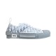 Side profile of Dior B23 low-top monogram trainer in grey and white cut out on white backdrop
