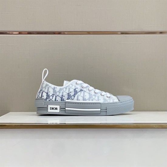 Lateral side view of white and grey Dior B23 low-top trainer showing branded side rubber panel
