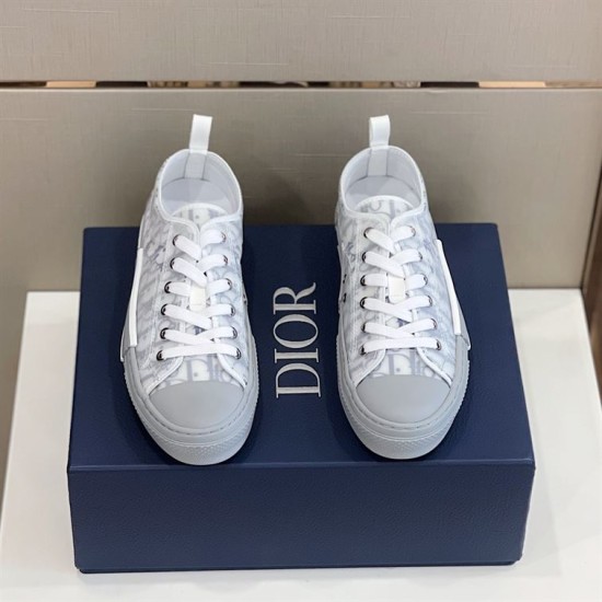Front view of both grey and white Dior B23 low-top trainers displaying lace-up closure and toe caps