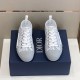 Front view of both grey and white Dior B23 low-top trainers displaying lace-up closure and toe caps