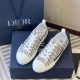 Pair of Dior B23 low-top trainers displayed alongside brand packaging in grey and white