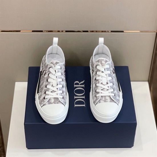 Top-down pair view of Dior B23 low-top Oblique trainers sitting on blue box in grey and white
