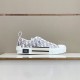 Side profile of grey and white Dior B23 low-top trainer displaying side logo patch