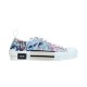 Side profile view of Dior B23 low-top trainer featuring blue and pink floral print