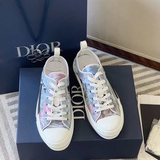 Overhead view of pair of Dior B23 floral print low-top trainers beside shoe box in blue and pink