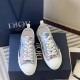 Overhead view of pair of Dior B23 floral print low-top trainers beside shoe box in blue and pink