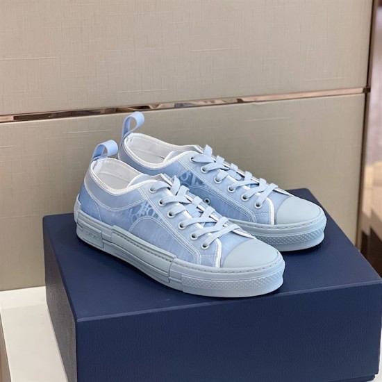 Dior B23 Light Blue Low Top Trainers Perspective View in light blue and white Three-quarter side angle of light blue Dior B23 low top trainers resting on shoe box in light blue and white
