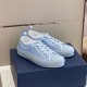 Dior B23 Light Blue Low Top Trainers Perspective View in light blue and white Three-quarter side angle of light blue Dior B23 low top trainers resting on shoe box in light blue and white