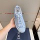 Dior B23 Light Blue Trainer Top View in light blue and white Top view of light blue Dior B23 trainer held showing lacing and branded inner sole in light blue and white