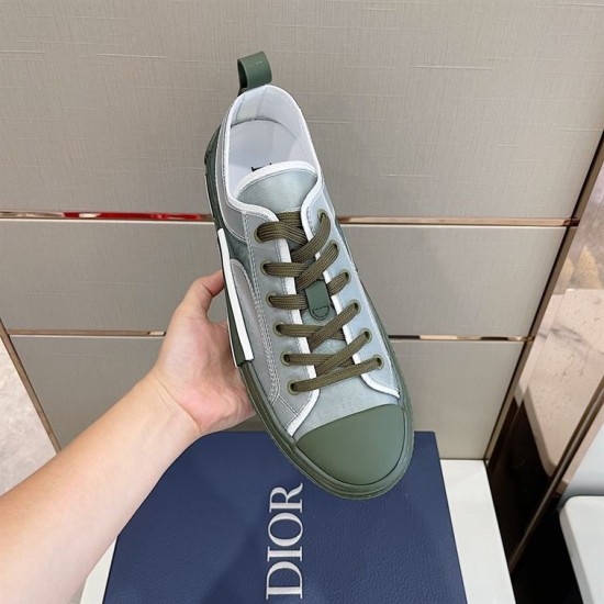 Dior B23 Low Top Trainers Green Oblique Canvas top view held in hand showing lacing and tongue in green and white