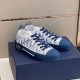 Three-quarter side angle of Dior B23 trainers resting together on packaging in blue