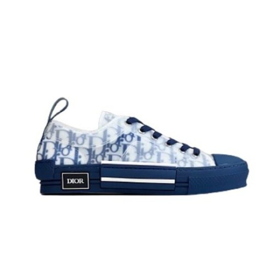 Isolated side view of Dior B23 low-top trainer in blue oblique canvas