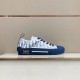 Profile view of Dior B23 blue low-top trainers displayed on a shelf