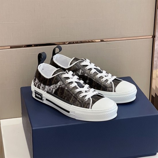 Dior B23 Low Top Black Monogram Canvas Trainers Angled View in black and white Angled view of Dior B23 Low Top Black Monogram Canvas Trainers sitting on box in black and white