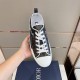Dior B23 Low Top Black Monogram Canvas Trainer Overhead View in black and white Overhead view of single Dior B23 Low Top Black Monogram Canvas Trainer held in hand in black and white