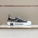 Dior B23 Low Top Black Monogram Canvas Trainers Side View in black and white Dior B23 Low Top Black Monogram Canvas Trainers lateral view on display surface in black and white