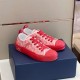 Pair of Dior B23 Low Top Red Oblique Canvas Trainers angled on dark box