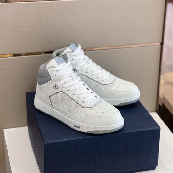 Dior High Top Leather Trainers Pair View in white and grey Pair of white and grey Dior high top leather trainers sitting on blue box