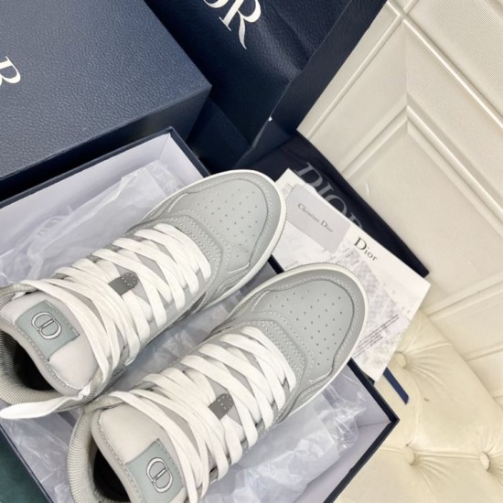 Dior B27 High-Top Grey Canvas Trainers - Packaging View in grey and white Top angle view of grey high-top trainers inside branded presentation box with tissue paper in grey and white