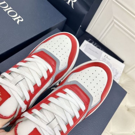 Close-up view of the perforated toe boxes and white laces on Dior B27 Red White Leather Trainers