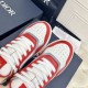 Close-up view of the perforated toe boxes and white laces on Dior B27 Red White Leather Trainers