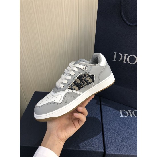 Dior B27 Low Top Grey White Canvas Low Top Trainers held up lateral view displaying canvas panel