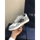 Dior B27 Low Top Grey White Canvas Low Top Trainers held up lateral view displaying canvas panel