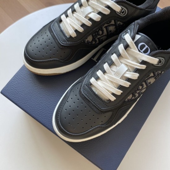 Close-up view of black leather toe cap and cream laces on Dior B27 trainers in black and white