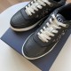 Close-up view of black leather toe cap and cream laces on Dior B27 trainers in black and white