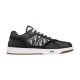 Dior B27 low-top leather trainer in black featuring oblique canvas side panels and white midsole on white background