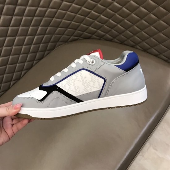 Dior B27 Low Top Grey White Canvas Trainer Outer Side Outer side panel view of Dior B27 Low Top Grey White Canvas Trainer held in hand