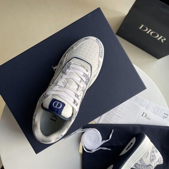 Top-down view of single Dior white and navy paisley trainer on shoe box