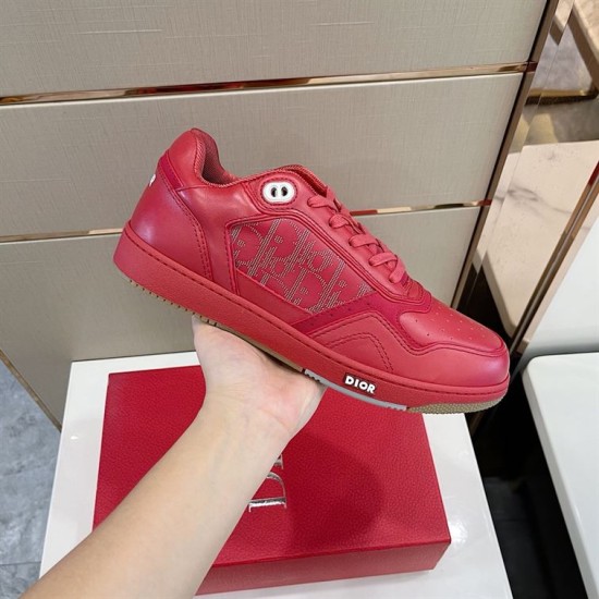 Dior B27 Low-Top Red Trainer Side Detail Hand holding Dior B27 low-top red leather trainer side profile