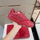 Dior B27 Low-Top Red Trainer Side Detail Hand holding Dior B27 low-top red leather trainer side profile