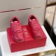 Pair of Dior B27 Red Trainers Front Angle Pair of Dior B27 red low-top trainers on display box top view