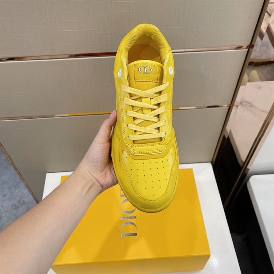 Top-down view of yellow Dior B27 low-top trainer showing toe box perforations