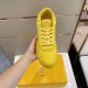 Top-down view of yellow Dior B27 low-top trainer showing toe box perforations