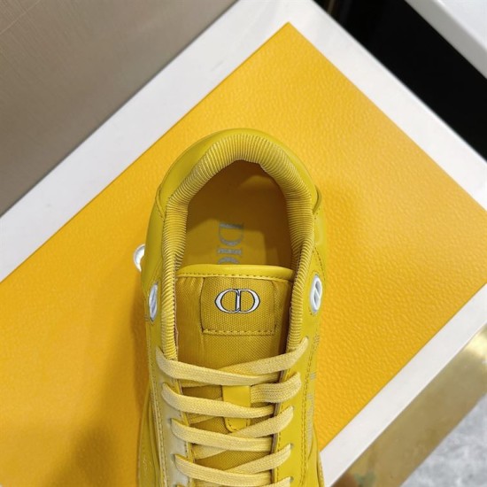Close-up view of padded tongue with CD logo on yellow Dior B27 trainer