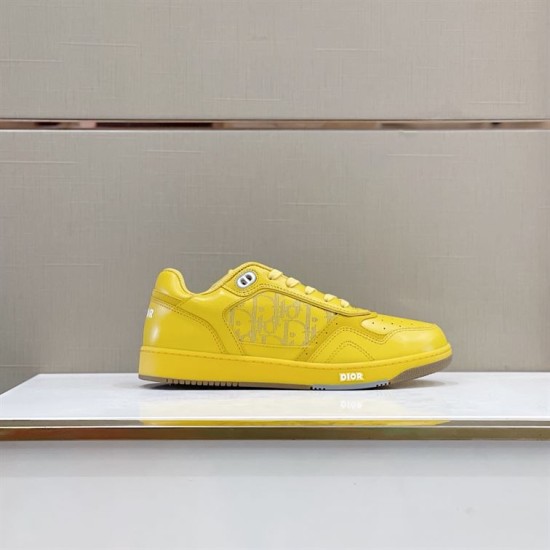 Dior B27 low-top yellow trainer standing on display surface