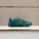 Side view of Dior B27 green low-top trainer displayed on a store shelf in green and white